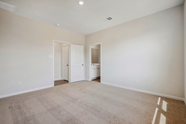 unfurnished bedroom featuring visible vents, carpet, and baseboards