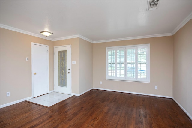 foyer entrance featuring baseboards, visible vents, wood finished floors, and ornamental molding
