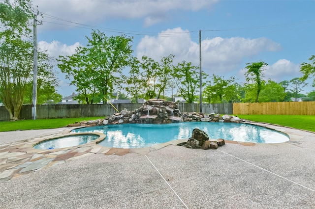 view of swimming pool featuring a lawn, a fenced backyard, a pool with connected hot tub, and a patio