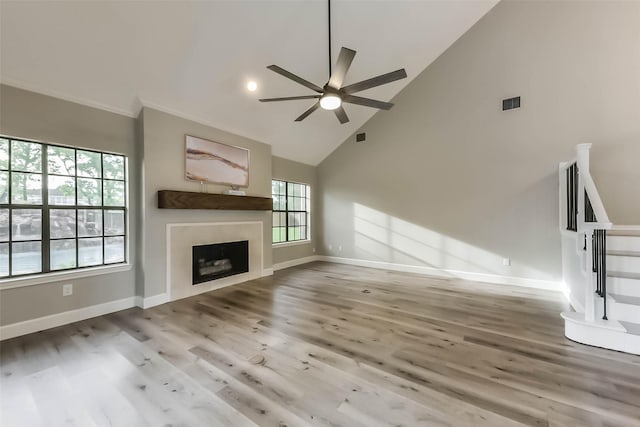 unfurnished living room featuring baseboards, ceiling fan, wood finished floors, and visible vents