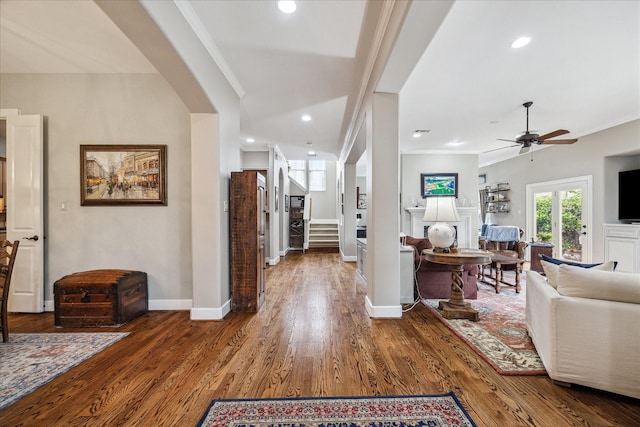 entrance foyer featuring crown molding, a ceiling fan, baseboards, and wood finished floors