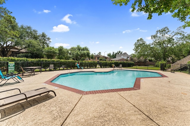 pool featuring a patio and fence
