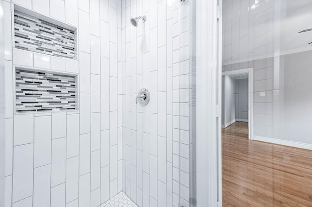 5807 Dumfries Dr, Houston, TX 77096 - full bath with baseboards, wood finished floors, a tile shower, and crown molding