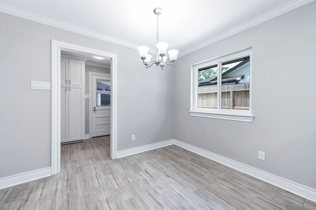5807 Dumfries Dr, Houston, TX 77096 - unfurnished dining area featuring baseboards, ornamental molding, an inviting chandelier, and light wood-style floors