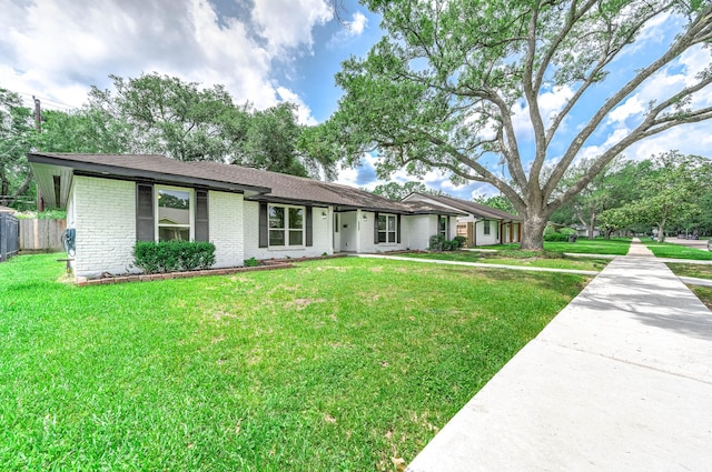 5807 Dumfries Dr, Houston, TX 77096 - ranch-style house featuring a front yard, fence, and brick siding