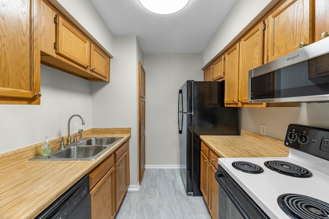 kitchen featuring stainless steel microwave, range with electric cooktop, light countertops, marble finish floor, and a sink
