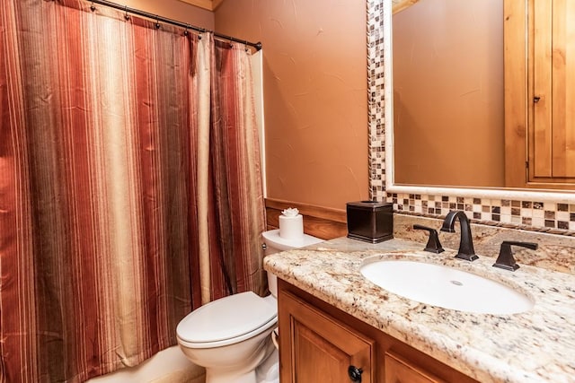 full bath featuring toilet, a shower with curtain, and vanity