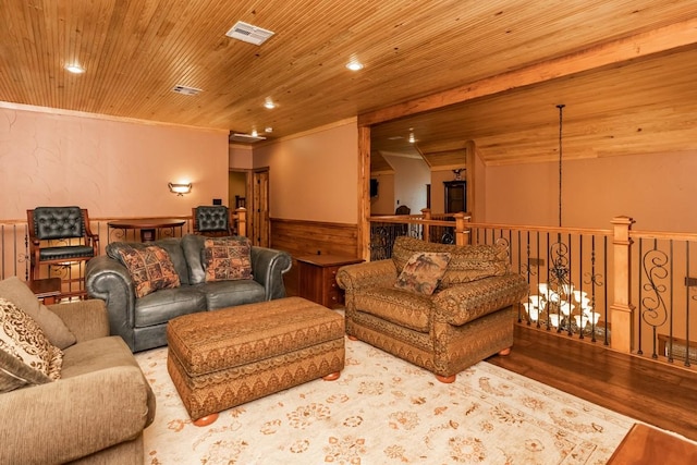 living room featuring recessed lighting, a wainscoted wall, visible vents, ornamental molding, and wood finished floors