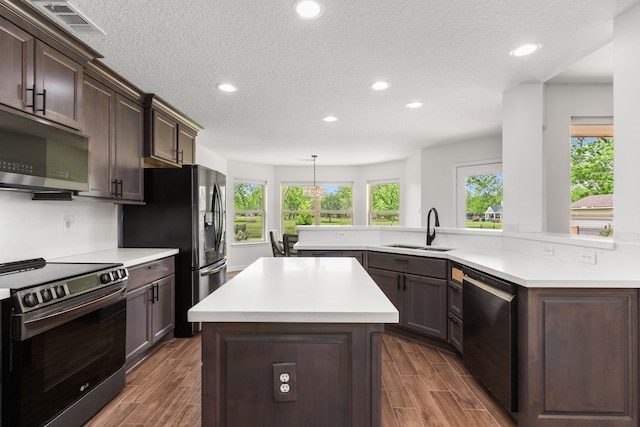 kitchen featuring recessed lighting, a sink, stainless steel appliances, and light countertops