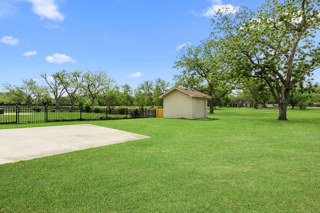 view of yard featuring an outbuilding, a patio, and fence