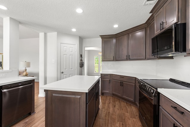 kitchen with light countertops, range with electric cooktop, dishwasher, and dark wood-type flooring