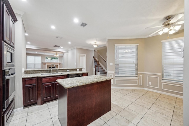 1339 Ella Pl, Houston, TX 77008 - kitchen with a ceiling fan, a kitchen island, stainless steel appliances, a peninsula, and ornamental molding