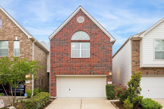 1339 Ella Pl, Houston, TX 77008 - traditional home featuring an attached garage, driveway, and brick siding