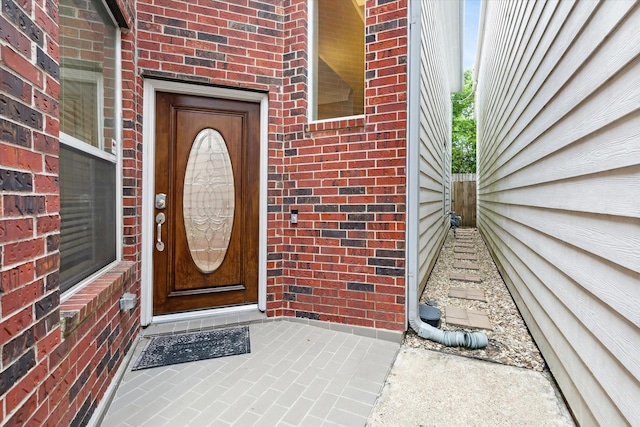 property entrance featuring brick siding