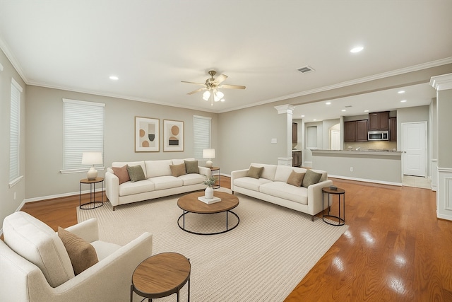 1339 Ella Pl, Houston, TX 77008 - living room with ceiling fan, light wood-style floors, crown molding, ornate columns, and recessed lighting