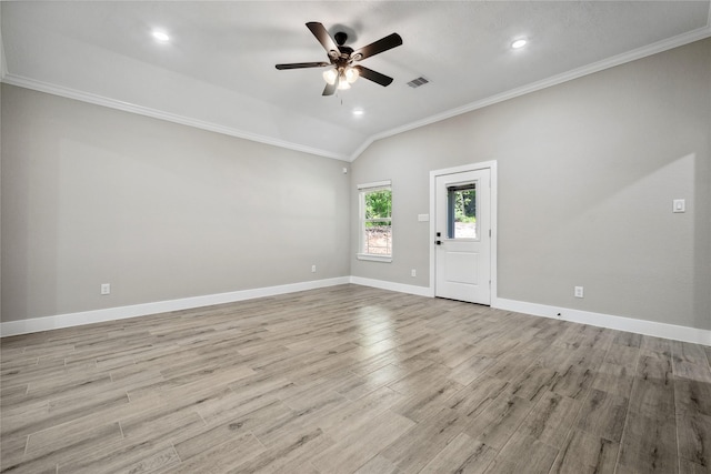 spare room with a ceiling fan, visible vents, baseboards, ornamental molding, and wood finished floors