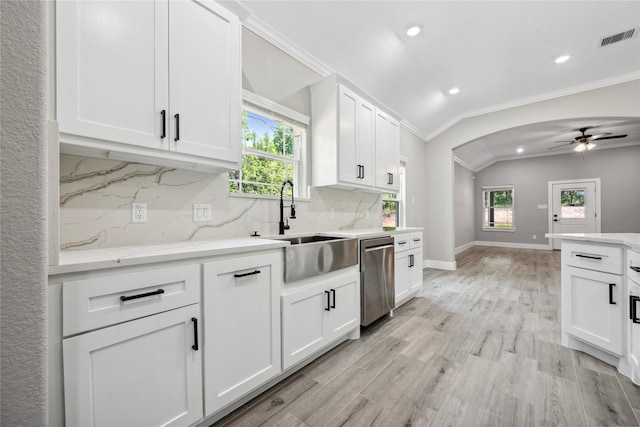kitchen featuring crown molding, visible vents, backsplash, stainless steel dishwasher, and arched walkways