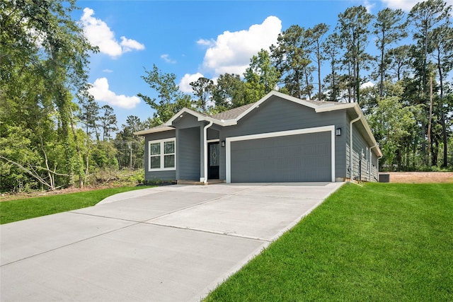 view of front facade with concrete driveway, a front lawn, and a garage