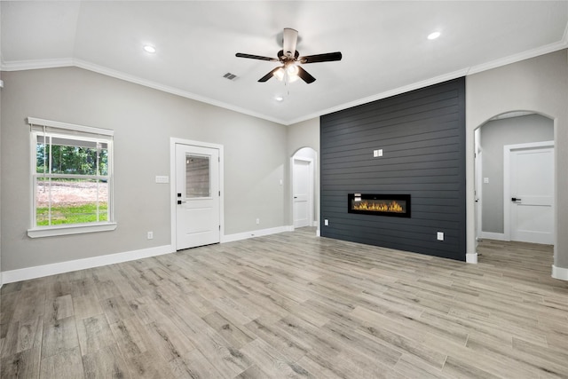 unfurnished living room with arched walkways, light wood-style floors, baseboards, visible vents, and a ceiling fan