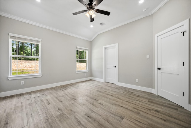 spare room with visible vents, ornamental molding, ceiling fan, and wood finished floors