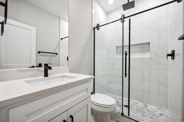 full bath featuring a shower stall, toilet, and vanity