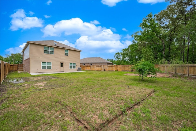 back of house with a patio, a fenced backyard, and a lawn