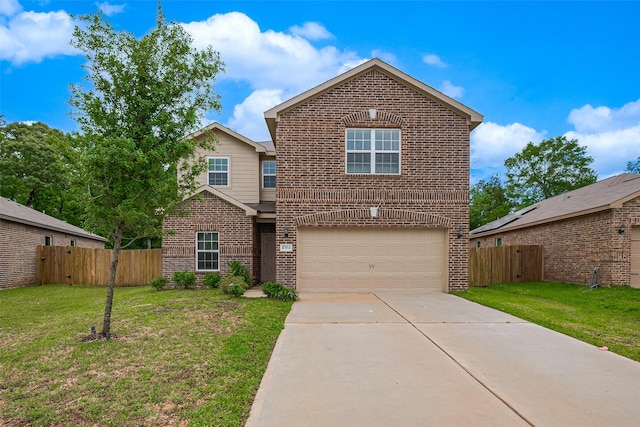 traditional home featuring brick siding, fence, driveway, a front yard, and an attached garage