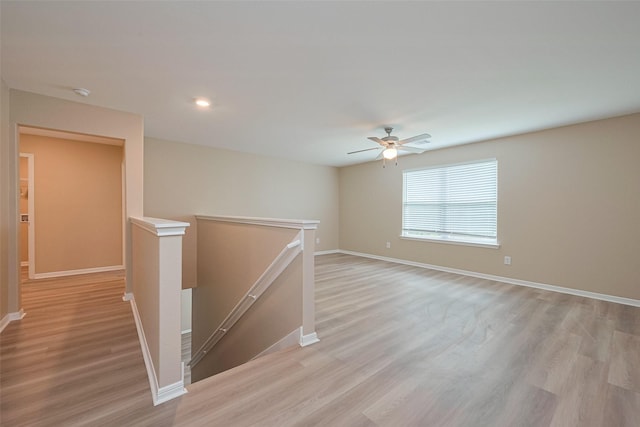 empty room featuring ceiling fan, recessed lighting, light wood-style flooring, and baseboards
