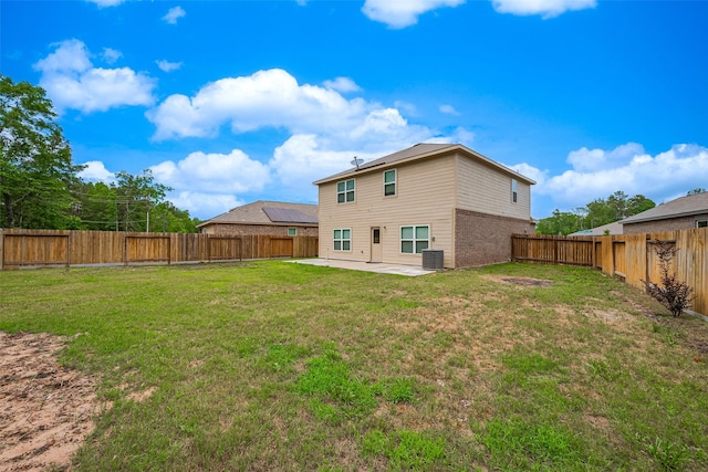 back of house featuring a fenced backyard, central air condition unit, a yard, and a patio area