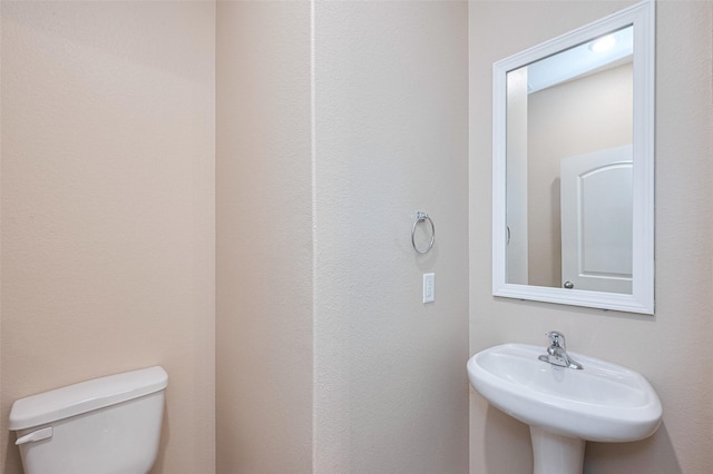 bathroom featuring toilet and a sink