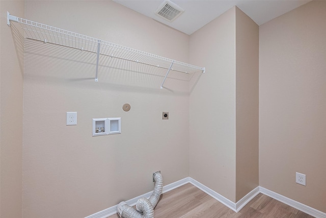 laundry area featuring washer hookup, electric dryer hookup, visible vents, light wood-style floors, and laundry area