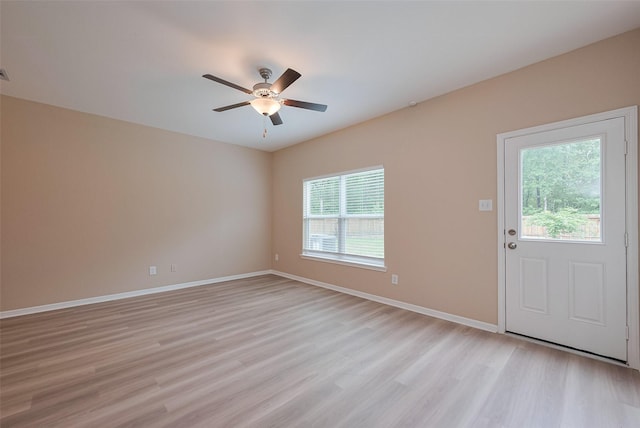 interior space with light wood-style floors, ceiling fan, and baseboards