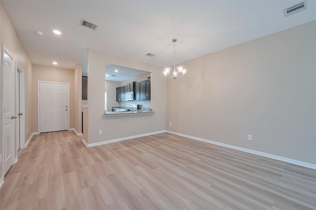 interior space featuring visible vents, an inviting chandelier, light wood-style floors, and recessed lighting