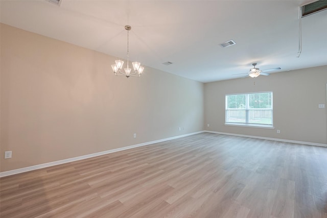 unfurnished room with visible vents, light wood-type flooring, baseboards, and ceiling fan with notable chandelier