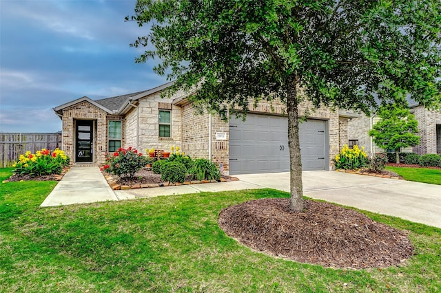 29031 Zacate Creek Ln, Fulshear, TX 77441 - view of front of property with a garage, fence, a front lawn, concrete driveway, and stone siding