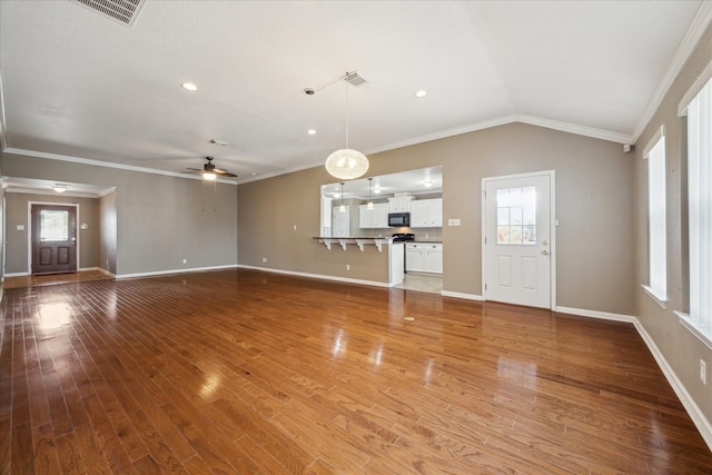 24 Clara Barton Ln, Galveston, TX 77551 - unfurnished living room featuring ceiling fan, plenty of natural light, crown molding, light wood finished floors, and baseboards