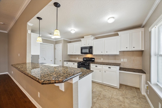 24 Clara Barton Ln, Galveston, TX 77551 - kitchen featuring black appliances, a sink, a peninsula, white cabinetry, and ornamental molding