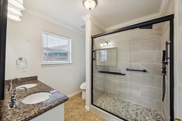 24 Clara Barton Ln, Galveston, TX 77551 - bathroom featuring crown molding, a stall shower, toilet, double vanity, and baseboards