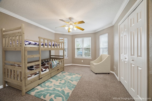 24 Clara Barton Ln, Galveston, TX 77551 - bedroom with carpet floors, ornamental molding, a textured ceiling, a closet, and baseboards