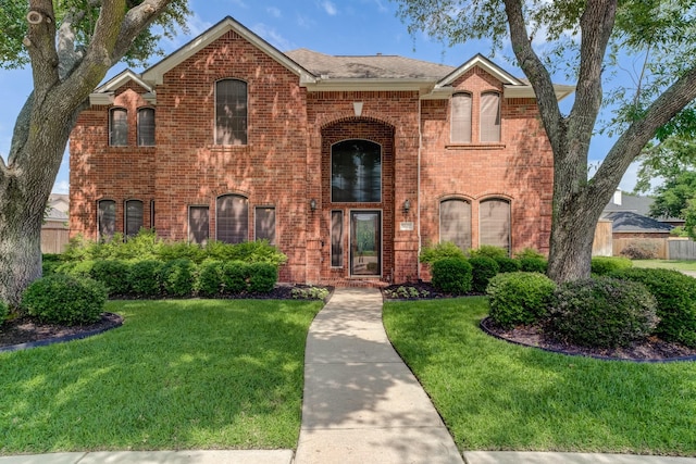 view of front facade featuring a front lawn and brick siding