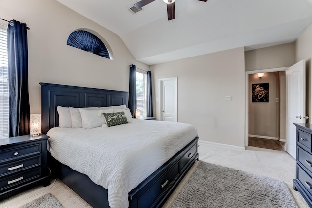 bedroom featuring light colored carpet, baseboards, visible vents, a ceiling fan, and lofted ceiling