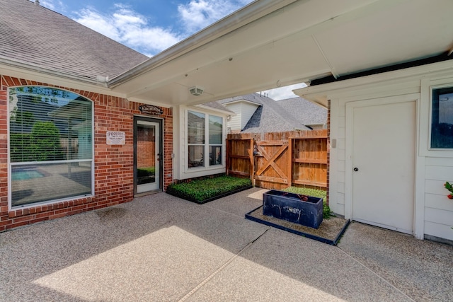 view of patio with fence and a gate