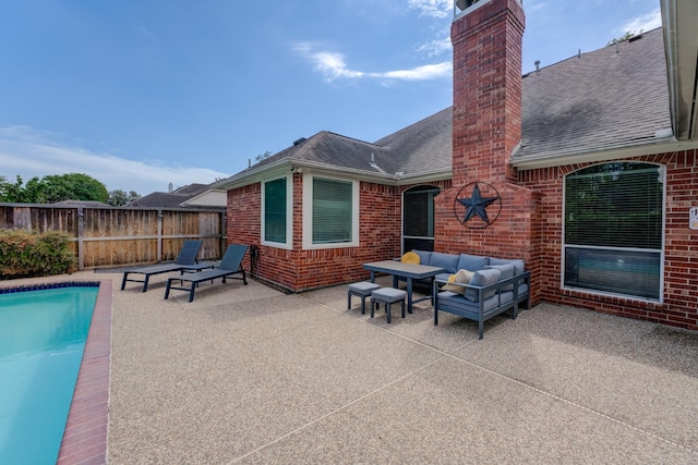 view of patio featuring fence, an outdoor living space, and a fenced in pool