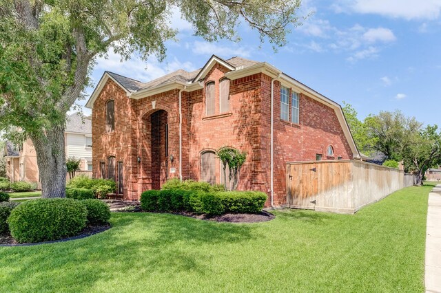 exterior space with brick siding and a yard