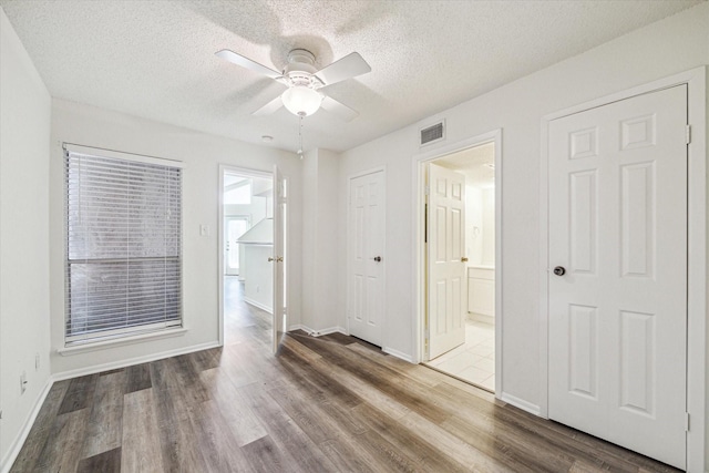10855 Meadowglen Ln Unit 1030, Houston, TX 77042 - interior space featuring a textured ceiling, visible vents, wood finished floors, and ensuite bath