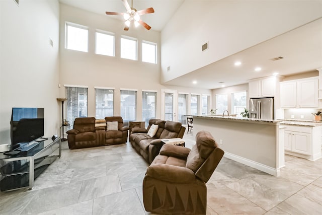 5722 Willow Park Terrace Ln, Porter, TX 77365 - living room with a ceiling fan, a towering ceiling, light marble finish flooring, healthy amount of natural light, and recessed lighting