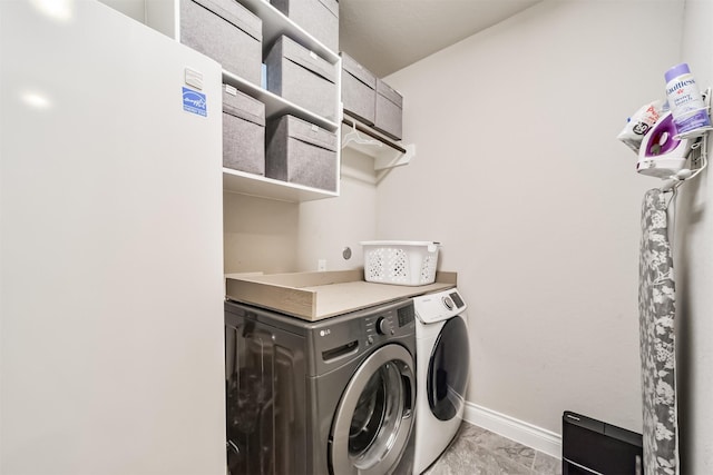 5722 Willow Park Terrace Ln, Porter, TX 77365 - laundry area with washing machine and dryer, baseboards, and light marble finish floors