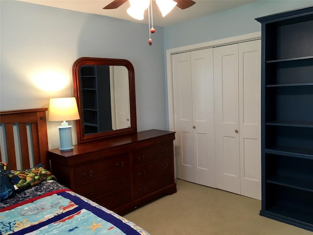 bedroom with a closet, a ceiling fan, and light carpet