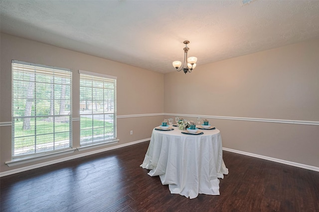 dining space featuring dark wood-type flooring, baseboards, a chandelier, and a healthy amount of sunlight