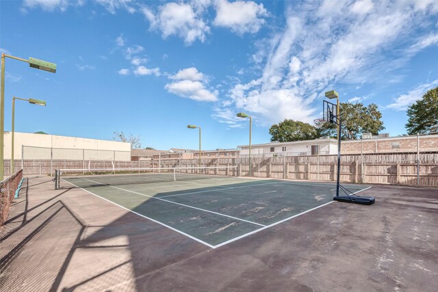 view of sport court with fence and a tennis court